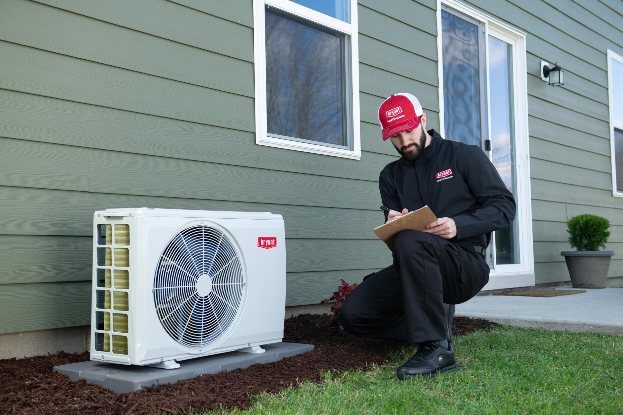 An authorized Bryant technician checking on a recently installed Bryant heat pump, as part of Power Ahead Colorado's rebates.