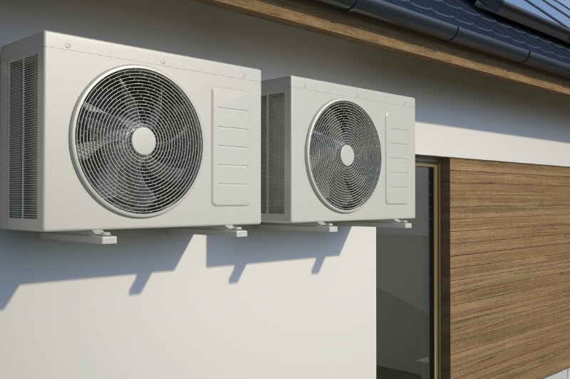 air conditioners attached to the side of a building.