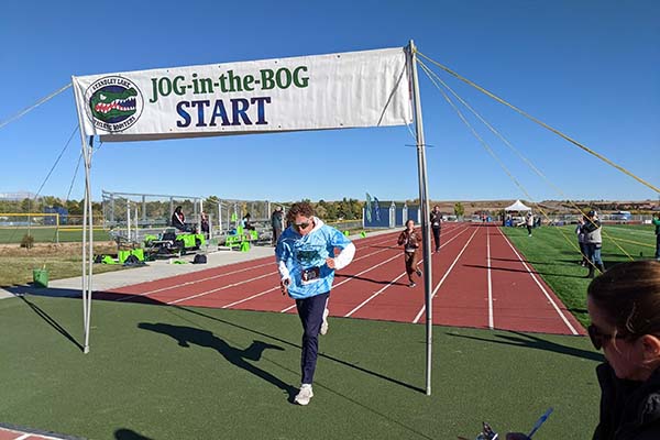 Man running on a track for the Efficient Comfort community event.