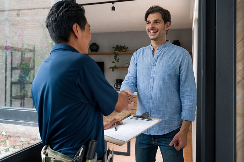 Technician and customer shaking hands.