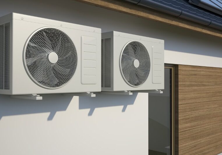 air conditioners attached to the side of a building.