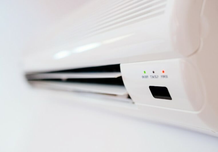 What is a Ductless AC? White home air conditioner mounted on apartment wall.