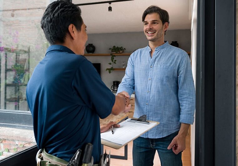 Technician and customer shaking hands.