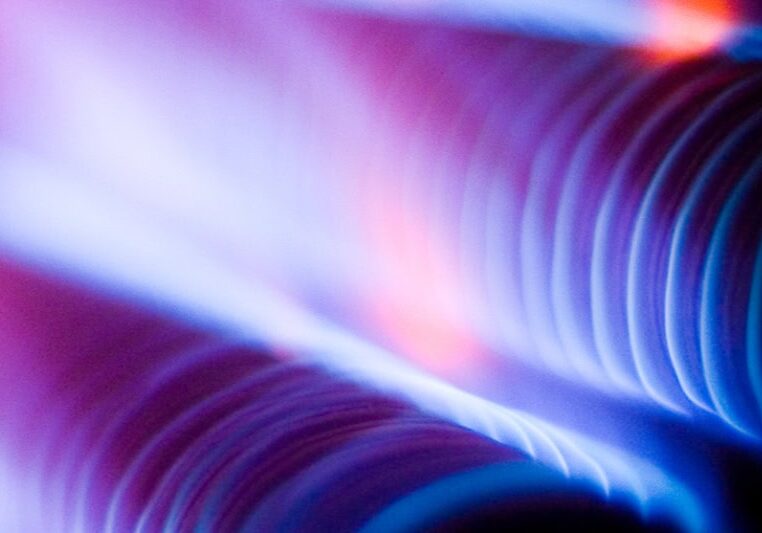 What Is That Burning Smell Coming From My Furnace? Close up photo of blue and red coils from inside a furnace.