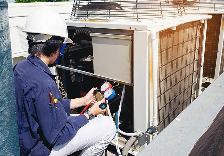 HVAC technician working on unit.
