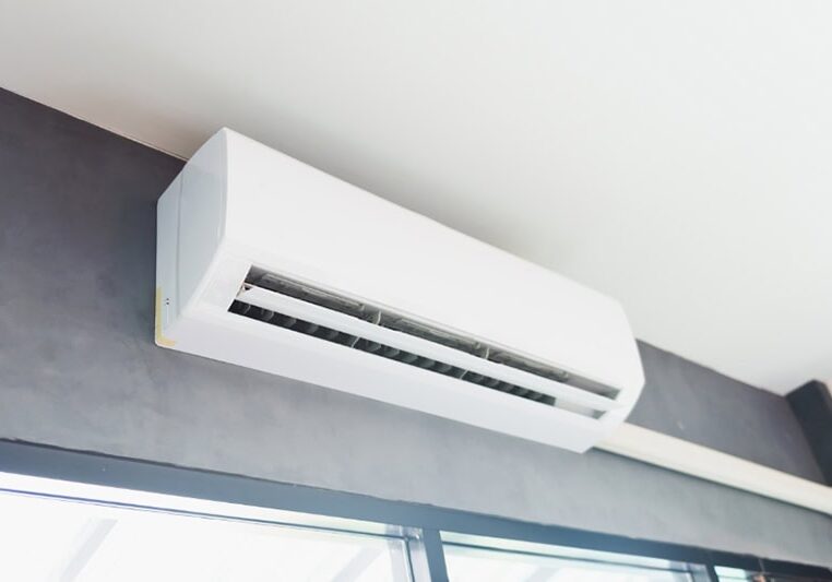 How Much Does it Cost to Install a Ductless Mini Split? Cool air conditioner swing system on wall in room.